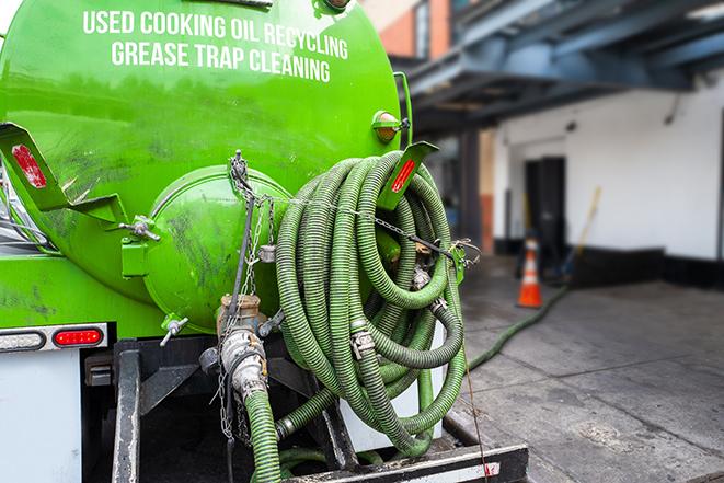 a vacuum truck pumping out a large underground grease trap in Bigfork